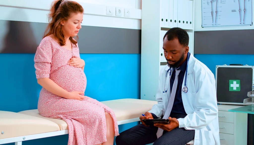 A pregnant woman safely discusses reproductive health with her doctor after the new HIPAA final rule has taken effect.