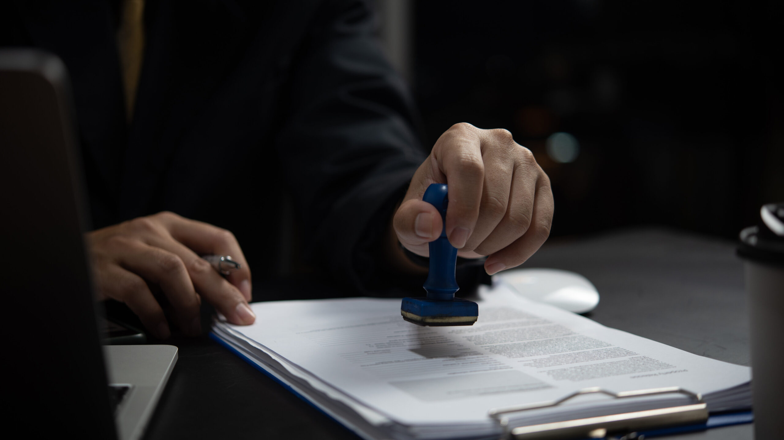 A Notary Applies a Stamp to Official Documents